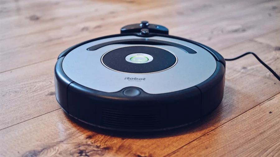 A robot vacuum cleaning a wooden floor